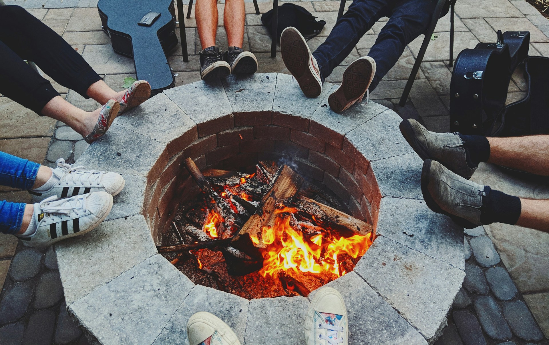 Friends gathering around a firepit, representing meaningful connection